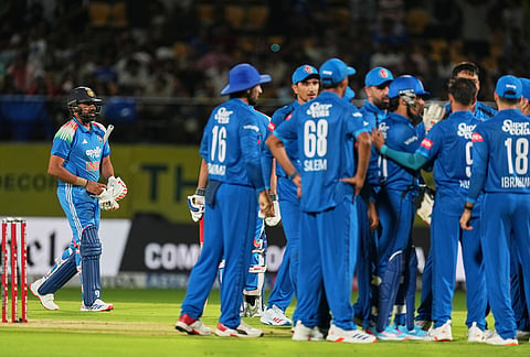 India's Rohit Sharma leaves the ground after losing his wicket as Afghanistan's players celebrate his run out during the first ODI cricket match between Afghanistan and India in Dharamshala.
