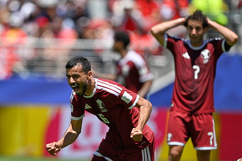 Qatar's Boualem Khoukhi celebrates after scoring his sides first goal during the World Cup Group B soccer match between Qatar and Switzerland in Santa Clara, Calif., near San Francisco, Saturday, June 13, 2026.