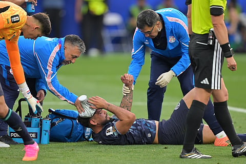 Trainers attend to Paraguay's Omar Alderete during the World Cup Group D soccer match against the United States in Inglewood, Calif., near Los Angeles, Friday, June 12, 2026.