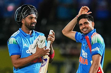 | Photo: AP/Ashwini Bhatia : India's captain Shubman Gill, right, KL Rahul celebrate their victory during the first ODI cricket match between Afghanistan and India in Dharamshala.