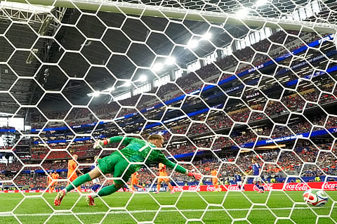 Netherlands goalkeeper Bart Verbruggen (1) is beaten by a shot from Japan's Keito Nakamura (13) for their first goal during the World Cup Group F soccer match between the Netherlands and Japan in Arlington, Texas, near Dallas, Sunday, June 14, 2026.