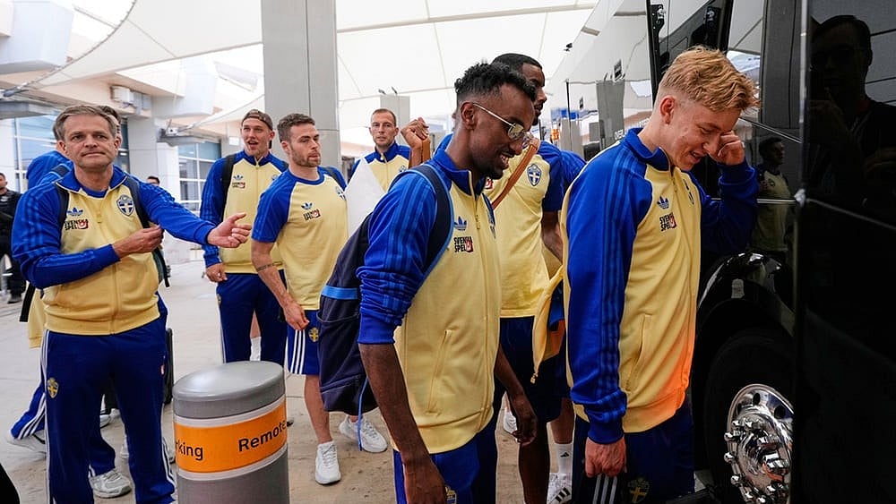 Taha Ali, center, and teammates board a bus after arriving at the Dallas Fort Worth International Airport, at DFW Airport, Texas, ahead of the World Cup soccer tournament.  - | Photo: AP/Tony Gutierrez