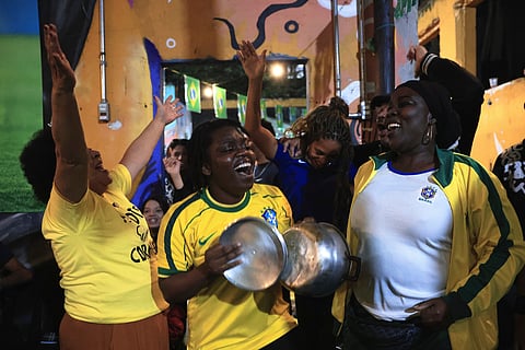 Fans celebrate a goal scored by Brazil against Morocco during a World Cup watch party at a housing occupation run by the Homeless Workers Movement, in Sao Paulo, Brazil, Saturday, June 13, 2026.