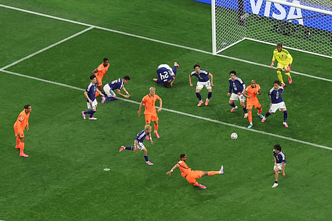 Netherlands' Cody Gakpo, bottom, shoots during the World Cup Group F soccer match between the Netherlands and Japan in Arlington, Texas, near Dallas, Sunday, June 14, 2026.