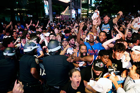 New York Knicks fans celebrate their victory after a watch party for Game 5 of the NBA Finals basketball series against the San Antonio Spurs in New York.