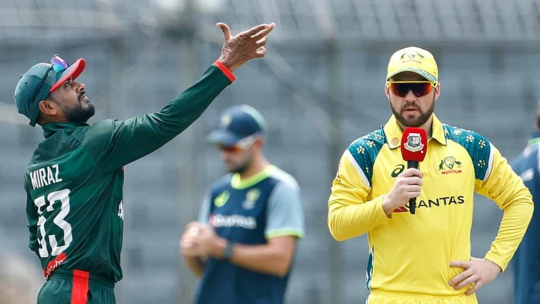 Bangladesh's captain Mehidy Hasan Miraz, left, tosses the coin for the toss as Australia's captain Josh Inglis looks during the second one day international cricket match between Australia and Bangladesh in Mirpur, Bangladesh. - | Photo: AP/Mosaraf Hossain