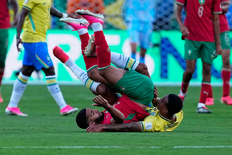 Morocco's Ismael Saibari, left, and Brazil's Gabriel Magalhaes fall to the pitch after challenging for possession during the World Cup Group C soccer match between Brazil and Morocco in East Rutherford, N.J., near New York, Saturday, June 13, 2026.