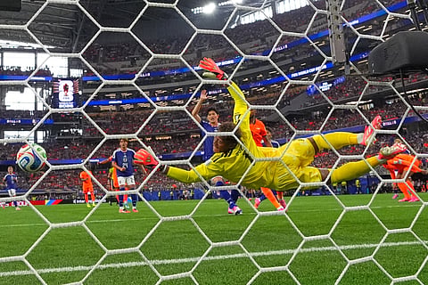 Japan goalkeeper Zion Suzuki (1) is beaten by a header from Netherlands' Virgil van Dijk (4) for the opening goal during the World Cup Group F soccer match between the Netherlands and Japan in Arlington, Texas, near Dallas, Sunday, June 14, 2026.