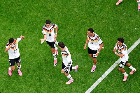 Germany's Kai Havertz is congratulated by teammates Jamal Musiala (10), Aleksandar Pavlovic (5), Felix Nmecha (23) and Nathaniel Brown (18) after scoring on a penalty kick during the World Cup Group E soccer match between Germany and Curacao in Houston, Sunday, June 14, 2026.