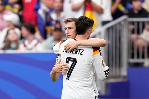 Germany's Kai Havertz celebrates with teammate Nico Schlotterbeck, left, after scoring his side's third goal during the World Cup Group E soccer match between Germany and Curacao in Houston, Sunday, June 14, 2026.