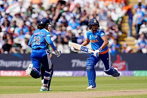 Photo: Jacob King/PA via AP : India's Smriti Mandhana, left, and Harmanpreet Kaur running between the wickets during the ICC Women's T20 World Cup, Group 1 cricket match between India and Pakistan in Birmingham, England.