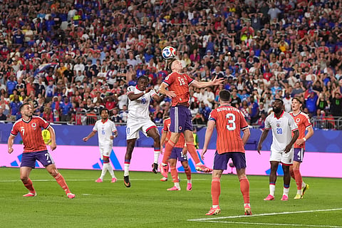 Scotland's Lewis Ferguson (19) heads the ball against Haiti's Jean-Ricner Bellegarde (10) during the World Cup Group C soccer match between Haiti and Scotland in Foxborough, Mass., near Boston, Saturday, June 13, 2026.