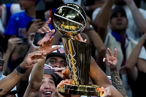 The New York Knicks celebrate with the Larry O'Brien Championship Trophy after defeating the San Antonio Spurs in Game 5 of the NBA Finals basketball series in San Antonio.