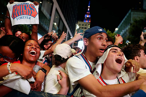 New York Knicks fans celebrate after winning Game 5 of the NBA Finals basketball series against the San Antonio Spurs in New York.