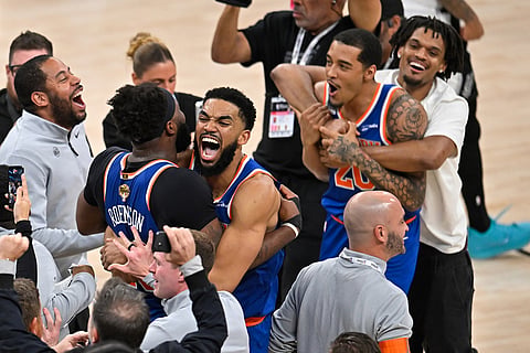 New York Knicks center Karl-Anthony Towns, right, hugs forward Og Anunoby during the after defeating the San Antonio Spurs in Game 5 of the NBA Finals basketball series in San Antonio.