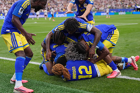 Curacao players celebrate after scoring during the World Cup Group E soccer match between Germany and Curacao in Houston, Sunday, June 14, 2026. 