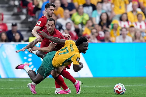 Turkey's Hakan Calhanoglu (10) and Australia's Nestory Irankunda (17) collide vying for the ball during first half Group D World Cup soccer action, in Vancouver, British Columbia, Saturday, June 13, 2026.