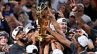 AP Photo/Darren Abate : The New York Knicks celebrate with the Larry O'Brien Championship Trophy after defeating the San Antonio Spurs in Game 5 of the NBA Finals basketball series, Saturday, June 13, 2026, in San Antonio.