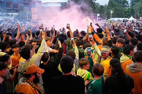Fans celebrate in Sydney, Sunday, June 14, 2026, after Australia defeated Turkey in their World Cup Group D soccer match.