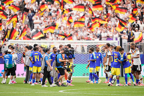 Germany, in white, and Curaçao, in blue, players react at the end of the World Cup Group E soccer match between Germany and Curacao in Houston, Sunday, June 14, 2026.