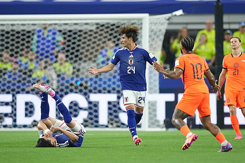 Japan's Shogo Taniguchi falls fouled by Netherlands' Memphis Depay (10) during a World Cup Group F soccer match in Arlington, Texas, near Dallas, Sunday, June 14, 2026.