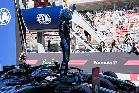 Mercedes driver George Russell of Britain celebrates his pole position after qualifying session for the Spain F1 Grand Prix at the Barcelona Catalunya racetrack in Montmelo, near Barcelona, Spain.