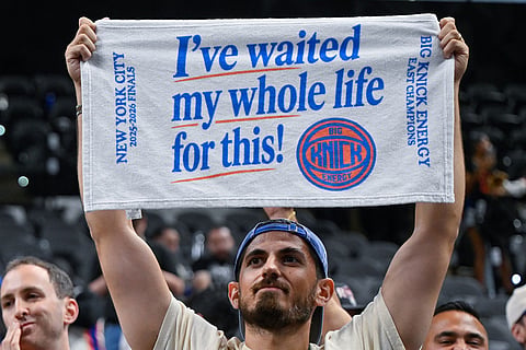 A New York Knicks fan celebrates after the Knicks defeated the San Antonio Spurs in Game 5 of the NBA Finals basketball series in San Antonio.