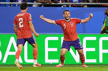 AP Photo/Martin Meissner : Scotland's John McGinn (7) celebrates with teammate Aaron Hickey (2) after scoring his team's first goal during the World Cup Group C soccer match between Haiti and Scotland in Foxborough, Mass., near Boston, Saturday, June 13, 2026.