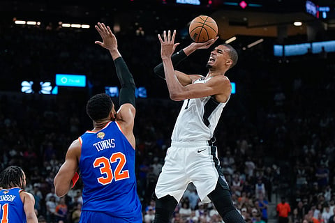 San Antonio Spurs forward Victor Wembanyama shoots as New York Knicks center Karl-Anthony Towns (32) defends during the first half of Game 5 of the NBA Finals basketball series in San Antonio.