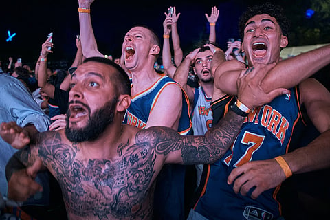 New York Knicks fans celebrate their victory after a watch party for Game 5 of the NBA Finals basketball series against the San Antonio Spurs in New York.