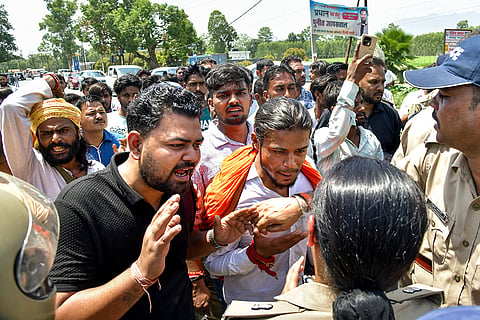 People gather as authorities raze "illegal" structures belonging to an accused, in the alleged killing of 44-year-old local BJP functionary in a clash on Saturday in Bairagiwala village, Dehradun. The deceased, Vinod, was allegedly killed on Saturday in a dispute over irrigation, and three members of his family were critically injured in the clash. 