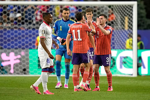 Scotland's Ryan Christie (11), Andy Robertson (3), Jack Hendry (13), and goalkeeper Angus Gunn (1) celebrate a win after the World Cup Group C soccer match between Haiti and Scotland in Foxborough, Mass., near Boston, Saturday, June 13, 2026.