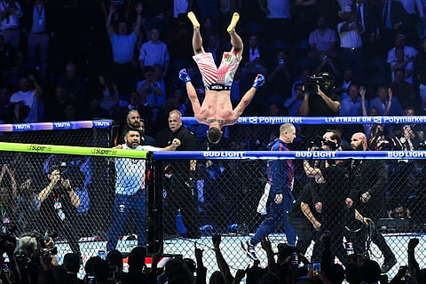 Justin Gaethje does a flip as he celebrates after defeating Ilia Topuria in a lightweight title bout during UFC Freedom 250 on the South Lawn of the White House in Washington.