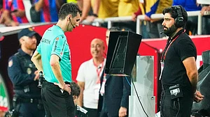 (AP Photo/Jose Breton, file) : A match official reviews footage on the VAR monitor amid growing controversy surrounding allegations against a FIFA World Cup official.