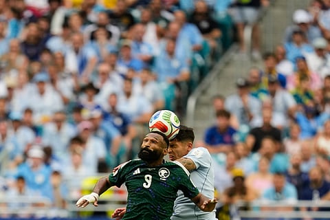 Saudi Arabia's Feras Albrikan (9) and Uruguay's Mathias Olivera go for a header during a World Cup Group H soccer match in Miami Gardens, Fla., Monday, June 15, 2026.