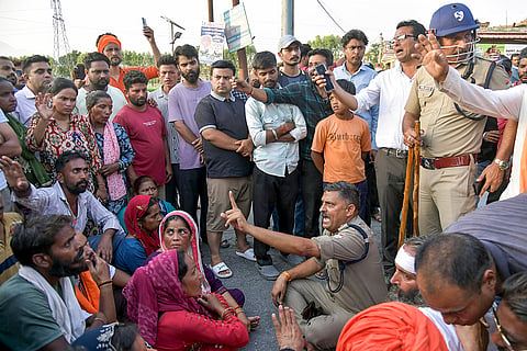 Security personnel conduct a flag march after Vinod Kumar a 44-year-old local BJP functionary was beaten to death and three members of his family were injured in an attack on their home by a group of people in Bairagiwala village, in Dehradun, Uttarakhand.