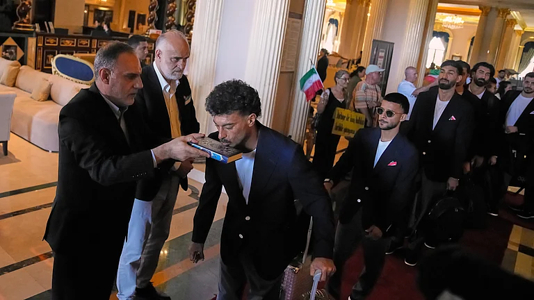 Iran's FIFA World Cup 2026-bound players kiss the Quran as they leave for Antalya Airport in southern Turkey, Saturday, June 6, 2026. From there, the team will depart for Tijuana, Mexico. - AP Photo/Khalil Hamra