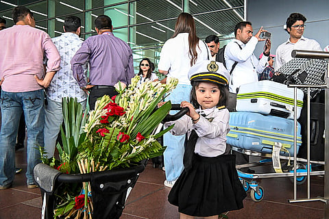 A child dressed as a pilot with a stroller carrying flowers at Noida International Airport, in Jewar, Uttar Pradesh, Monday, June 15, 2026. Commercial flight operations at the airport commenced.