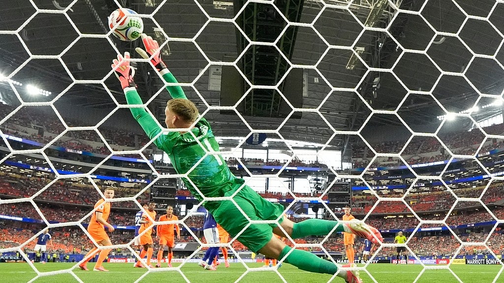 Netherlands goalkeeper Bart Verbruggen (1) is beaten by a header from Japan's Daichi Kamada (15) for their second goal during the World Cup Group F soccer match between the Netherlands and Japan in Arlington, Texas, near Dallas, Sunday, June 14, 2026. - AP Photo/Tony Guttierez