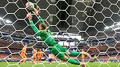 Netherlands goalkeeper Bart Verbruggen (1) is beaten by a header from Japan's Daichi Kamada (15) for their second goal during the World Cup Group F soccer match between the Netherlands and Japan in Arlington, Texas, near Dallas, Sunday, June 14, 2026. - AP Photo/Tony Guttierez