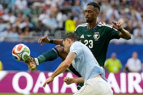 Saudi Arabia's Mohamed Kanno controls the ball as Uruguay's Matias Vina challenges during a World Cup Group H soccer match in Miami Gardens, Fla., Monday, June 15, 2026.