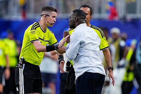 Referee Francois Letexier gestures to Ivory Coast head coach Emerse Fae during the World Cup Group E soccer match between Ivory Coast and Ecuador in Philadelphia, Sunday, June 14, 2026.