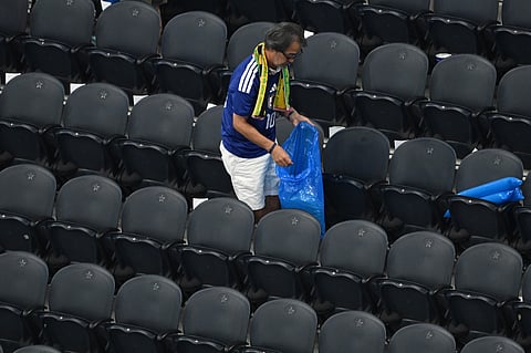 Japan fans clean up trash in the stadium following the World Cup Group F soccer match between the Netherlands and Japan in Arlington, Texas, near Dallas, Sunday, June 14, 2026.