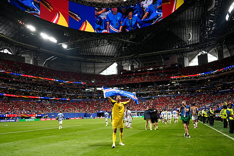 Cape Verde goalkeeper Vozinha celebrates as holds the flag of his country during the World Cup Group H soccer match between Spain and Cape Verde in Atlanta, Monday, June 15, 2026.