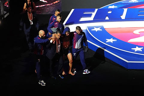 Ilia Topuria is helped out of the stadium after being defeated by Justin Gaethje in a lightweight title bout during UFC Freedom 250 on the South Lawn of the White House in Washington.