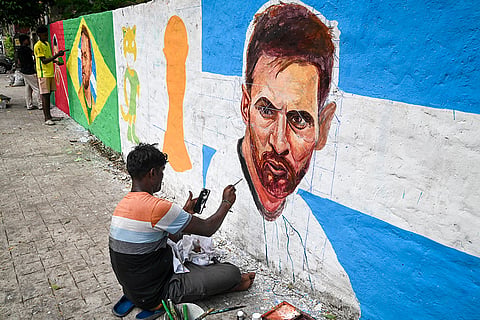Artists paint a mural featuring Argentina National team footballer Lionel Messi, Portugal National team fottballer Cristiano Ronaldo and Brazil National team footballer Neymar Jr amid the ongoing FIFA World Cup 2026, in Kolkata, West Bengal.