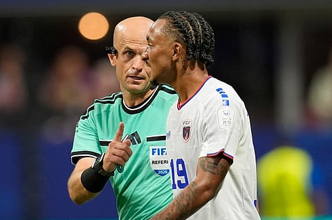 Referee Adham Makhadmeh from Jordan speaks with Cape Verde's Dailon Livramento (19) during the World Cup Group H soccer match between Spain and Cape Verde in Atlanta, Monday, June 15, 2026.