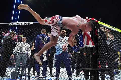 Justin Gaethje jumps from the ring after beating Ilia Toupruia in the lightweight championship bout at UFC Freedom 250 on the South Lawn of the White House in Washington.