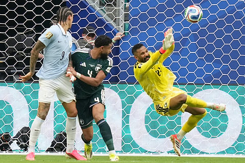 Saudi Arabia goalkeeper Mohammed Alowais stops a shot during a World Cup Group H soccer match against Uruguay in Miami Gardens, Fla., Monday, June 15, 2026.