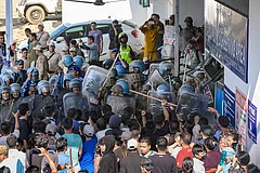 Security personnel stop protesters near the Regional Institute of Medical Sciences (RIMS), in Imphal. - | Photo: PTI